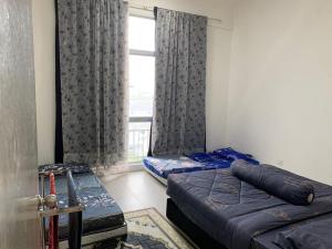 a bedroom with two beds and a window at Alliv NSF Studio & 1 Bedroom Apartment Stay in Brinchang