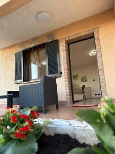 eine Terrasse mit einem Tisch, Stühlen und einem Fenster in der Unterkunft Casa Ninetta Marco Simone in Marco Simone