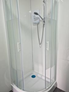 a shower with a glass enclosure in a bathroom at Pad in Cardiff