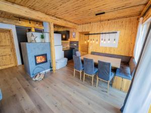 a dining room with a table and a fireplace at Woody 17 in Sankt Lorenzen ob Murau