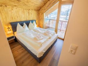a bedroom with a bed and a large window at Woody 17 in Sankt Lorenzen ob Murau