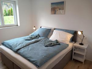 מיטה או מיטות בחדר ב-Feriennest Ossiachersee