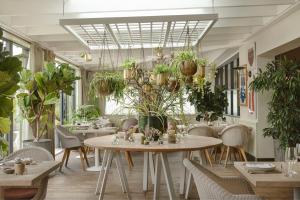 a restaurant with tables and chairs and potted plants at The Gallivant in Rye