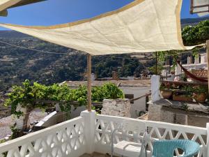 a white balcony with a view of a valley at Casa Tradicional Alpujarreña in Capileira