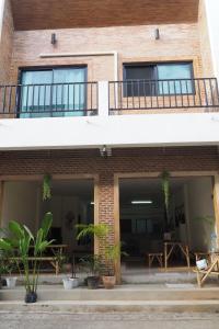 a brick building with a balcony and a patio at Poke Pai Home in Pai