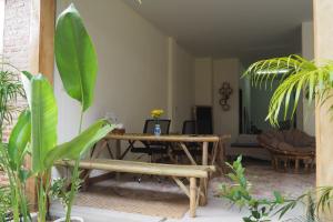 a living room with a table and some plants at Poke Pai Home in Pai