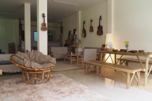 a living room with tables and guitars on the wall at Poke Pai Home in Pai