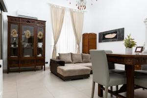 a living room with a couch and a table at Zefnea House in Catania