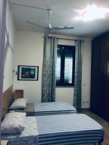 a bedroom with two beds and a window at b&b IL QUADRATO 19 in Nerviano