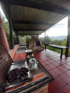 an outdoor stove with a pot on top of it at Finca la Riverita in Sutamarchán