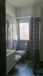 a bathroom with a toilet and a sink and a shower at Villa Giulia in Pozzuoli