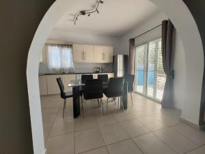 a kitchen and dining room with a table and chairs at Kato Paphos 2 Bedroom House - Tourist location in Paphos City