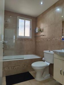 a bathroom with a toilet and a tub and a sink at Kato Paphos 2 Bedroom House - Tourist location in Paphos City