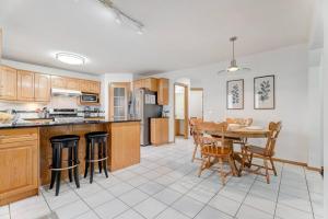 a kitchen and dining room with a table and chairs at Coral Springs Lakefront Retreat in Calgary