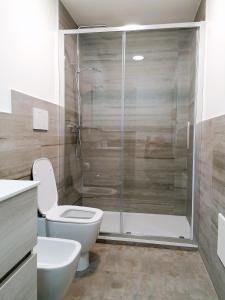 a bathroom with a toilet and a glass shower at Golf Club Marco Simone in Marco Simone