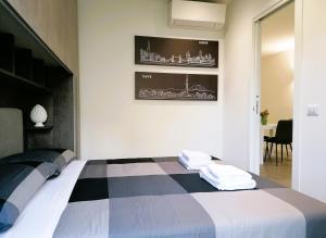 a bedroom with a black and white bed with towels on it at Golf Club Marco Simone in Marco Simone