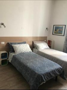 a bedroom with two beds at b&b IL QUADRATO 19 in Nerviano