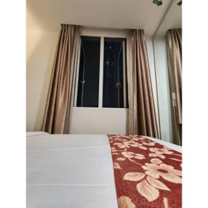 Postel nebo postele na pokoji v ubytování Sakura Elite Kuala Lumpur