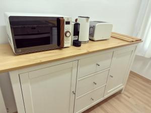 a counter with a microwave and other appliances on it at Ruta del ferro in Ripoll