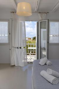 a bedroom with a bed with two towels on it at Soulmate's Suites Tinos in Kionia