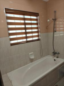 a white bath tub in a bathroom with a window at Unit 89 Pendleberry Holiday Resort in Bela-Bela