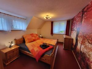 a bedroom with a bed with a teddy bear on it at Ferienhaus Sonnenblick Schmilka in Schmilka