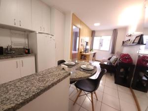 cocina y sala de estar con mesa y sillas en Sweet Home Sudoeste - Completo e aconchegante, en Brasilia