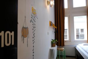 a bedroom with a bed and a window at Hostel & Bar De Basis in Zwolle