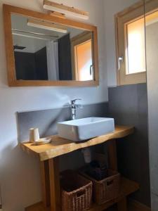 a bathroom with a sink and a mirror at Chalet le jardin de fées in Saint-Gervais-les-Bains
