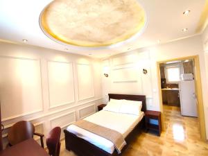 a bedroom with a bed with a large ceiling at Villa Miltiadis GreeceFilloxenia in Volos