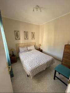 1 dormitorio con 1 cama y 1 silla azul en Apartamento Fabian, en Guardiola de Berguedà