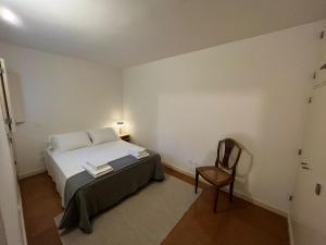 a bedroom with a bed and a chair in it at Porto Siza Apartment in Porto