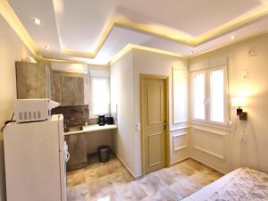a kitchen with a white refrigerator and a window at Villa Miltiadis GreeceFiloxenia in Volos
