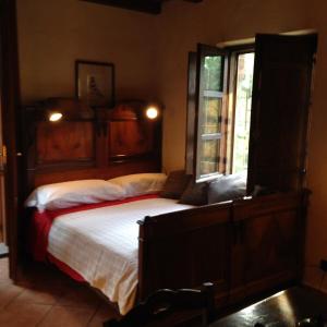 a bedroom with a large bed and a window at Country House in Zerbolò