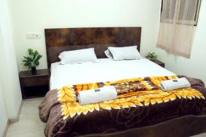 a bedroom with a large bed with two pillows on it at Hotel Taj Bi Plaza in Aurangabad