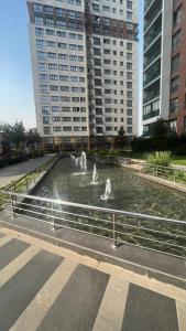 a fountain in the middle of a city with buildings at Luxury privet 3 bed room 1 saloon security Nearby vadi istanbul 10min to mall of Istanbul and city centre private spa & winter pool for women in Istanbul