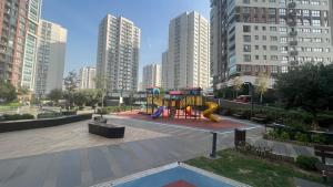 a playground in a city with tall buildings at Luxury privet 3 bed room 1 saloon security Nearby vadi istanbul 10min to mall of Istanbul and city centre private spa & winter pool for women in Istanbul