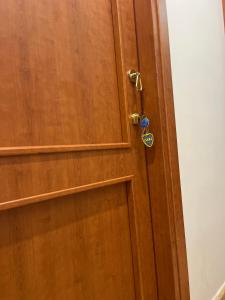 a wooden door with a lock on it at Residence El Diez in Naples