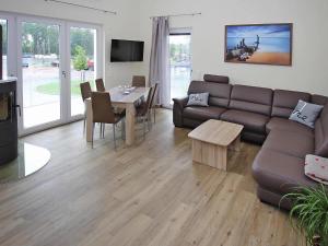 a living room with a couch and a table at Appartement Hafenflair am Plauer See in Plau am See +15 photos