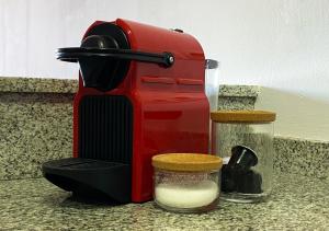 a red toaster sitting on a counter next to a glass jar at Barcelona Beach Breeze in Barcelona