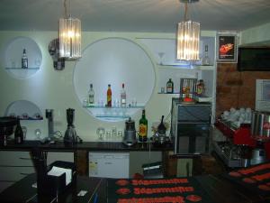 a room with a bar with bottles on the wall at Pensiunea La Busu in Bran