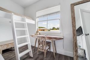 a room with a desk and a ladder and a window at Treehouse Hotel in Miami