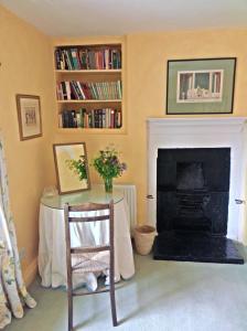 a living room with a table and a fireplace at Barmoors in Lastingham