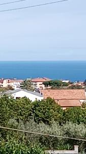 a view of a city with the ocean in the background at B&B "LE LUCI" CAMERA IN ATTICO GRAN VISTA interno 4 in Vasto