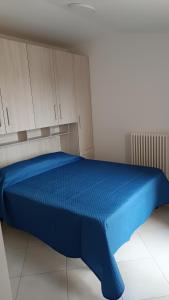 a blue bed in a room with white cabinets at B&B "LE LUCI" CAMERA IN ATTICO GRAN VISTA interno 4 in Vasto
