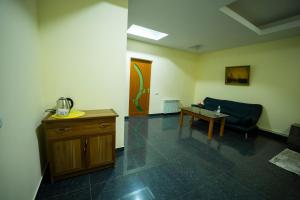 a living room with a couch and a table at Continental Hotel Complex in Yerevan