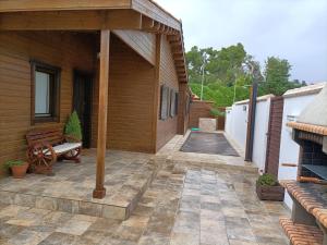 un patio al aire libre con un banco y una casa en La Dehesa2 de Toledo, en Cobisa