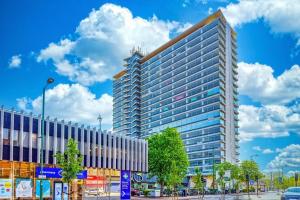 a tall building on a street in a city at Surbiton Home with free parkings, Surbiton, Kingston upon Thames, Surrey, Greater London UK in Surbiton