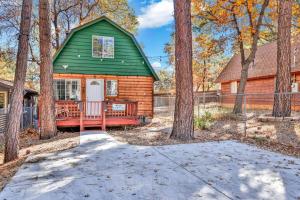 a log home with a green roof and trees at Apres Chalet Retreat~ Hot Tub~ Relax Away Cottage~ in Sugarloaf