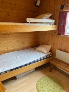 a room with two bunk beds in a cabin at Välplanerad ski-in/out stuga med bastu in Gällivare